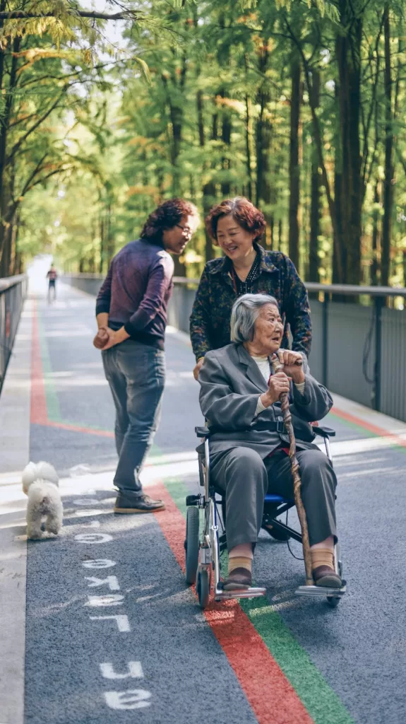 woman walking with her mum on a wheel chair