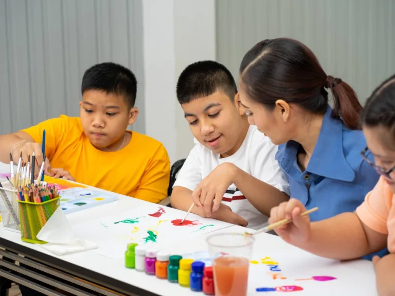 kids painting with their teacher
