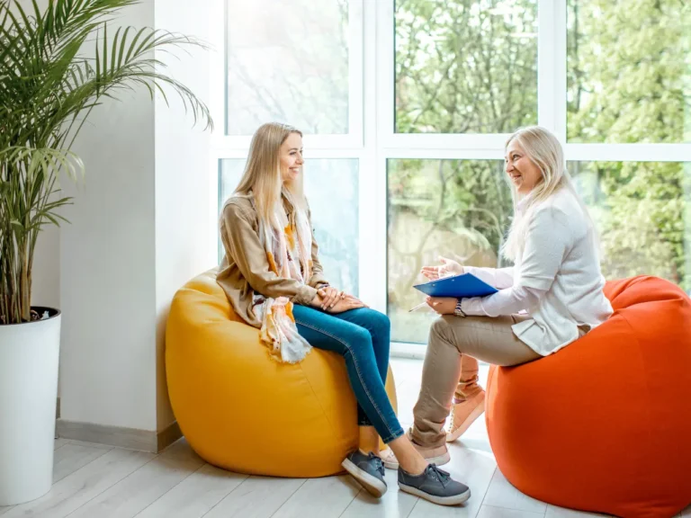 a woman having a face to face relaxed conversation with her plan manager