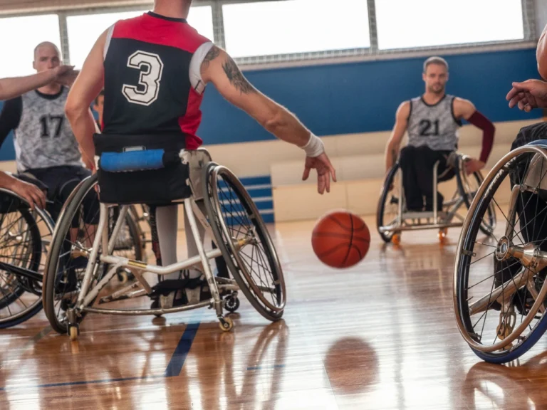 men in sports wheelchairs playing and enjoying basketball